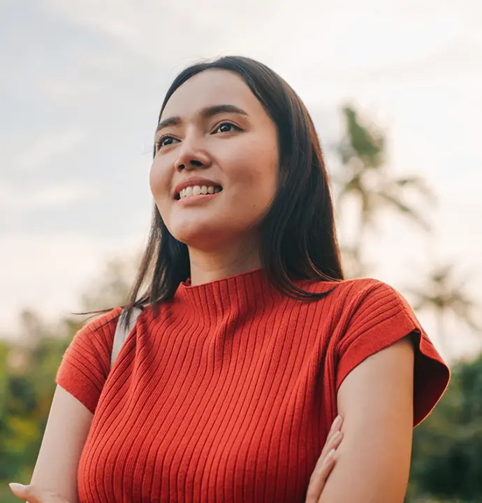 woman smiles and crosses her arms
